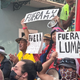 Puerto Ricans took to the streets of San Juan to protest LUMA outages on August 25, 2022. They hold signs that read “get out LUMA” in Spanish.